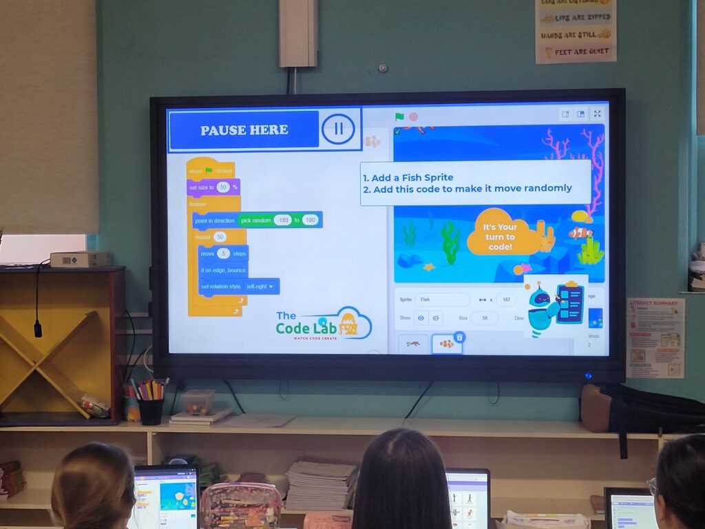 Pupils following a structured coding lesson during class time